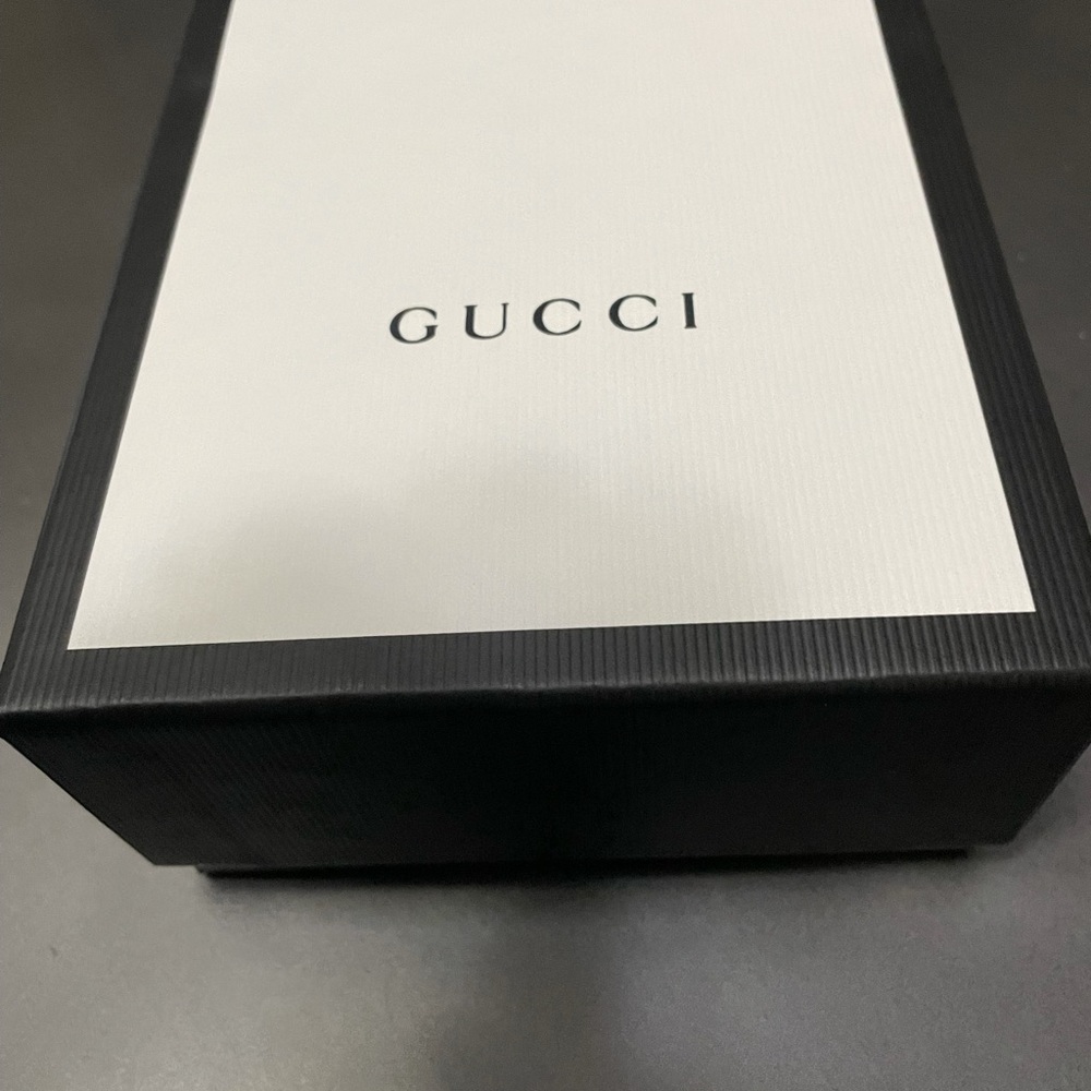 Gucci box and storage bag for a woman’s wallet